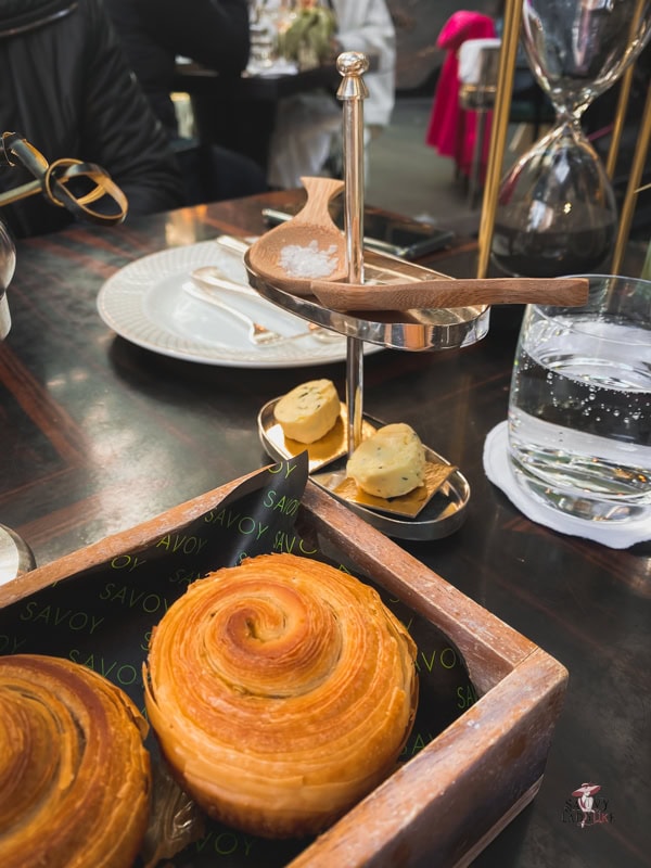 How to be an Elegant woman: Finally Seen, Heard, and Command Respect 23 Close up photo of fluffy pastry in a wooden tray with butter and sale on the side, an afternoon tea serving from The Savoy hotel